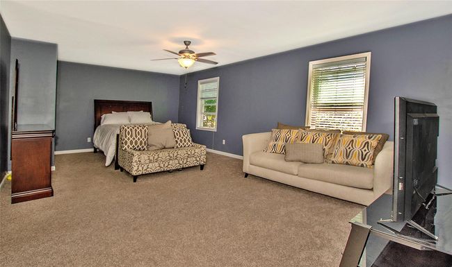 Master Bedroom with multiple windows, ceiling fan, and carpet | Image 10