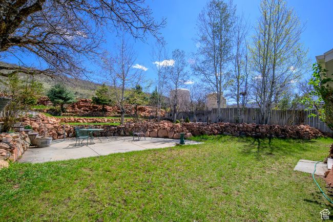 View of yard with a fenced backyard and a patio area | Image 71
