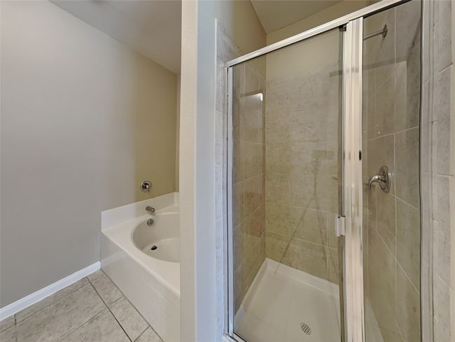 Full bath with a garden tub, a stall shower, and tile patterned flooring | Image 9