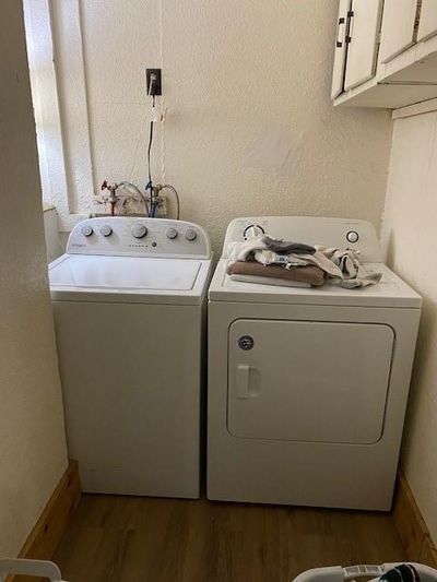 Laundry room with independent washer and dryer, dark hardwood / wood-style floors, and cabinets Have it all in one room and out of sight. | Image 3