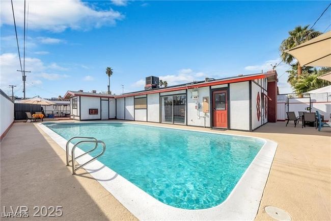 View of swimming pool with a patio area and central air condition unit | Image 24