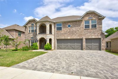 View of front of home featuring a garage and a front yard | Image 2