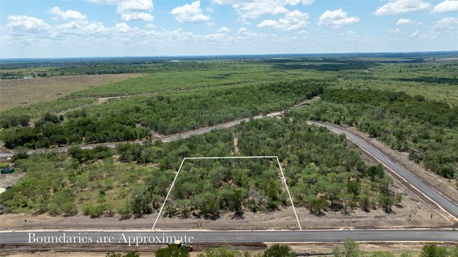 Aerial view of property and surrounding area with property parcel outlined and a heavily wooded area | Image 6