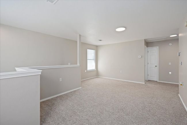 Unfurnished room featuring attic access, baseboards, and carpet floors | Image 24