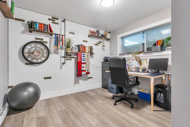 Home office with baseboard heating, wood finished floors, and baseboards | Image 26