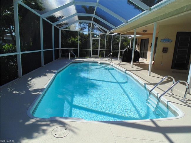 Pool with a patio and glass enclosure | Image 28