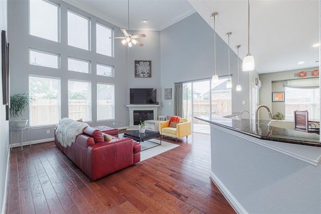. Spacious family room features soaring ceilings, gaslog fireplace & a wall of windows overlooking the backyard. | Image 20