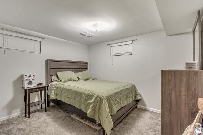 Carpeted bedroom featuring visible vents and baseboards | Image 14