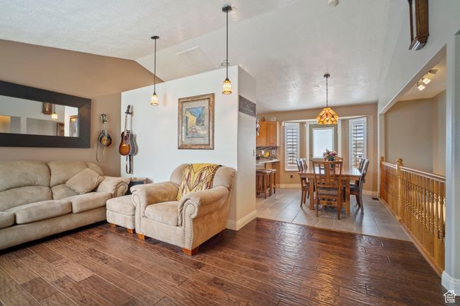 Living area featuring hardwood / wood-style floors, baseboards, and lofted ceiling | Image 4