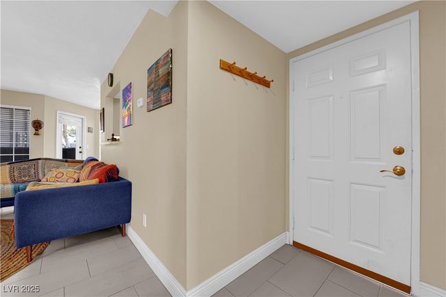 Entryway featuring light tile patterned floors and baseboards | Image 4