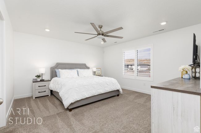 Bedroom featuring light colored carpet, visible vents, recessed lighting, and baseboards | Image 21