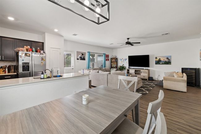 Dining space featuring ceiling fan, dark wood finished floors, and recessed lighting | Image 22