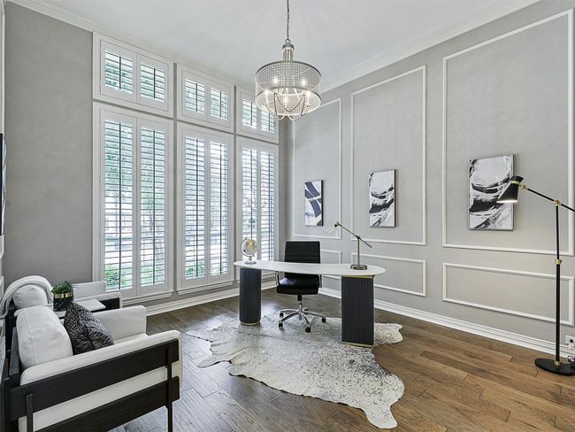 Home office featuring a chandelier, a decorative wall, ornamental molding, and dark wood-type flooring | Image 10