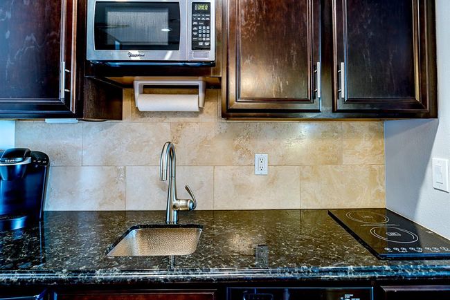 Granite counter top in kitchen area with small sink | Image 8