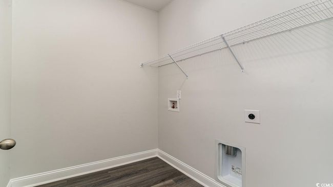 Clothes washing area featuring hookup for an electric dryer, hardwood / wood-style floors, and washer hookup | Image 11