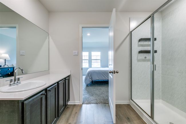 Bathroom with vanity, wood-type flooring, and a shower with shower door | Image 15