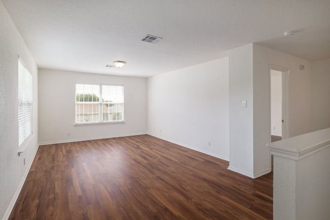 Unfurnished room with dark wood-style floors, visible vents, and baseboards | Image 19