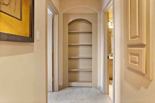 Hallway outside one of the bedrooms with Trendmakers famous hidden door to storage plus a huge walk in attic. On the wall to your right is a built in laundry shoot. | Image 29