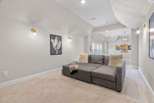 Living room with lofted ceiling, carpet floors, baseboards, and a chandelier | Image 29