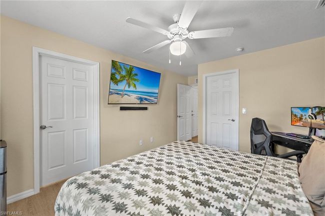 Bedroom with wood finished floors, baseboards, and ceiling fan | Image 12