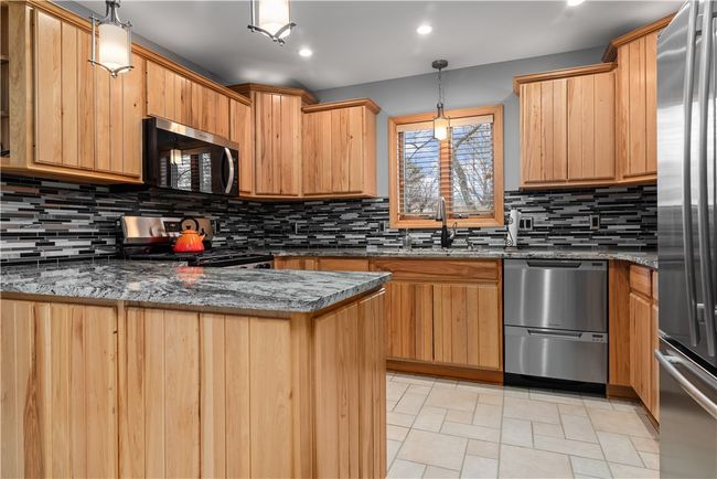 Closer look at the kitchen counter tops and cabinets. | Image 9