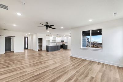 Unfurnished living room with ceiling fan, light hardwood / wood-style flooring, and sink | Image 3