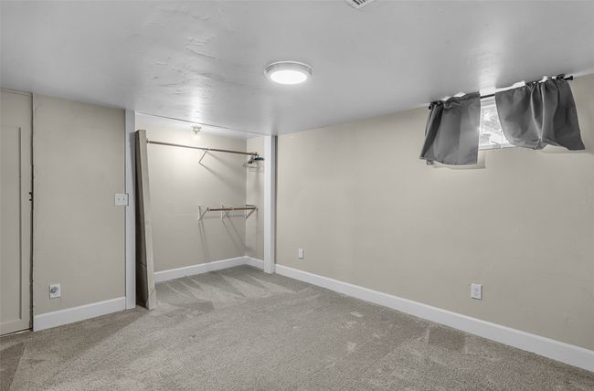 Unfurnished bedroom with light colored carpet and baseboards | Image 28