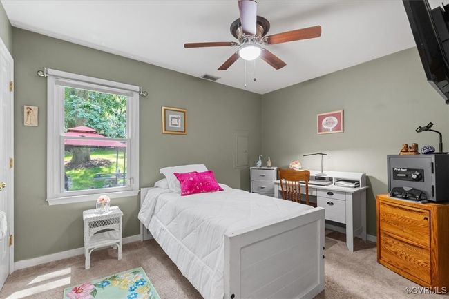 Bedroom with light carpet, baseboards, and ceiling fan | Image 24
