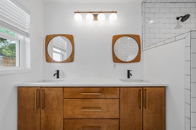 Full bathroom featuring double vanity and a shower | Image 17