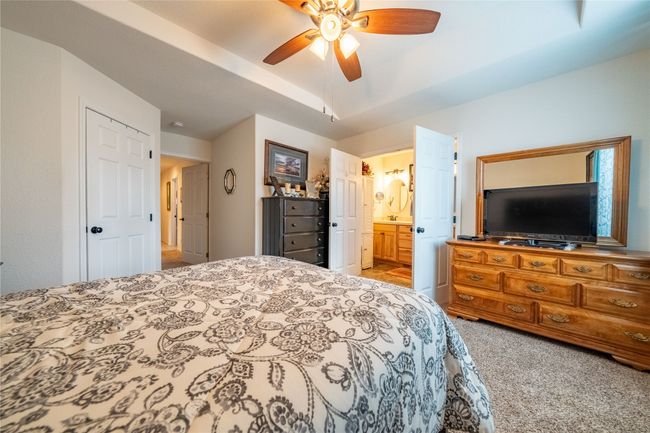 Bedroom featuring ensuite bath, a ceiling fan, and carpet floors | Image 10