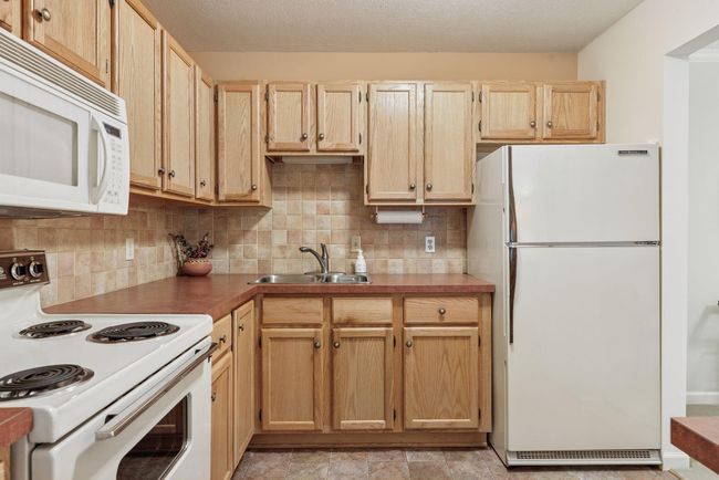 Compact kitchen with ample cabinet storage and a convenient layout for cooking | Image 5