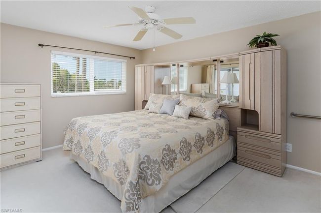 Bedroom with baseboards, light colored carpet, and ceiling fan | Image 10