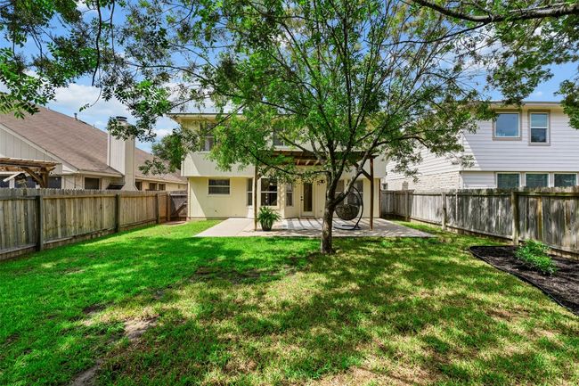 Rear view of house with a patio and a fenced backyard | Image 32