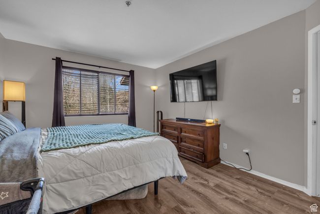 Bedroom with wood finished floors and baseboards | Image 9