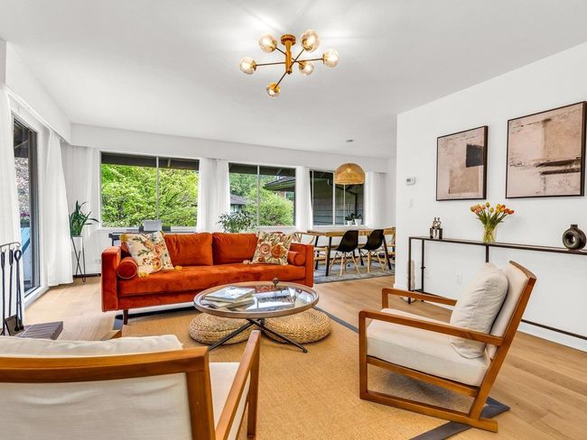 Living room with light wood-style floors and a chandelier | Image 8