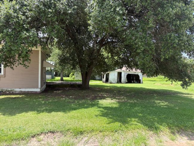 View of green lawn featuring an outbuilding | Image 6