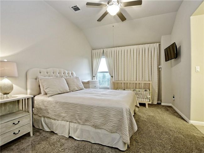 Carpeted bedroom with lofted ceiling and a ceiling fan | Image 16