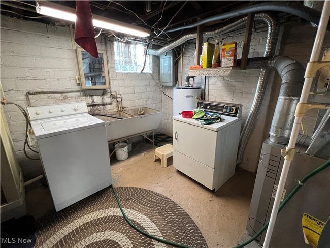 Clothes washing area with electric panel, sink, and heating unit | Image 13
