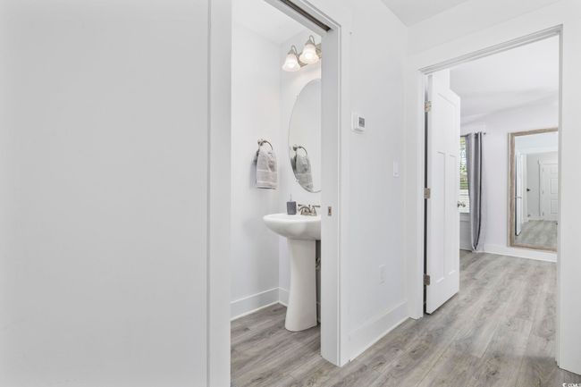 Bathroom featuring wood finished floors, baseboards, and a sink | Image 27