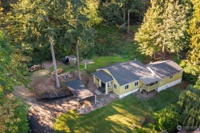 This cute country home is nestled on a peaceful acre with woods to explore. | Image 1