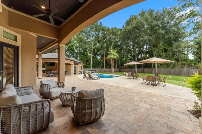 Step outside into your own private resort, where the covered patio with extended decking invites year-round enjoyment.. | Image 36