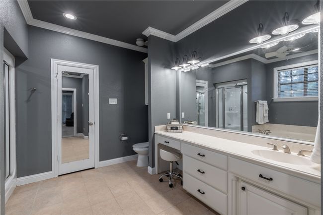 First Primary bathroom with a shower stall, vanity, crown molding, and tile patterned floors | Image 23