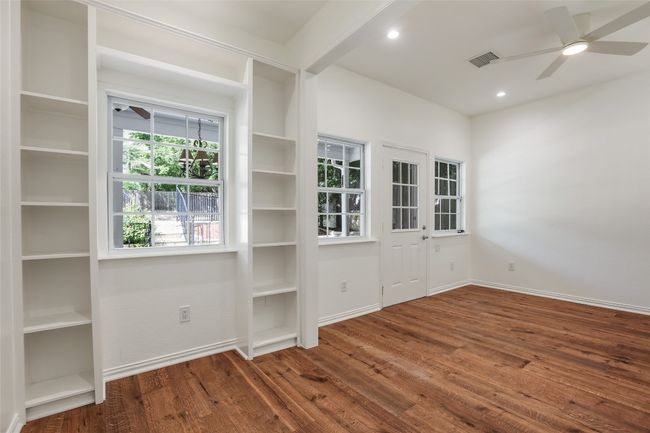 Empty room featuring a ceiling fan, wood finished floors, and recessed lighting | Image 13