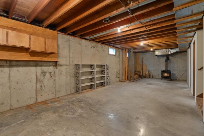 Below grade area featuring a wood stove | Image 17