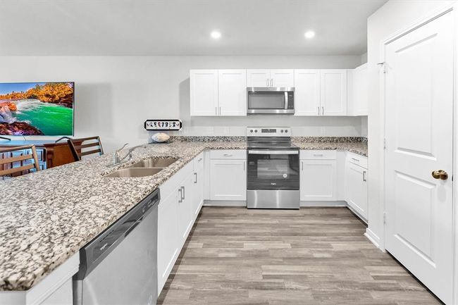 Large open kitchen with plenty of counter space. | Image 21