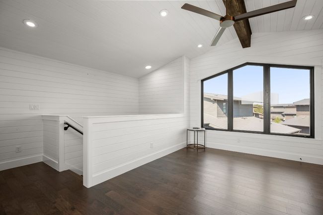 The beautiful design is carried through this entire home-the beamed ceiling and picture window add character to the functional bonus room. | Image 22