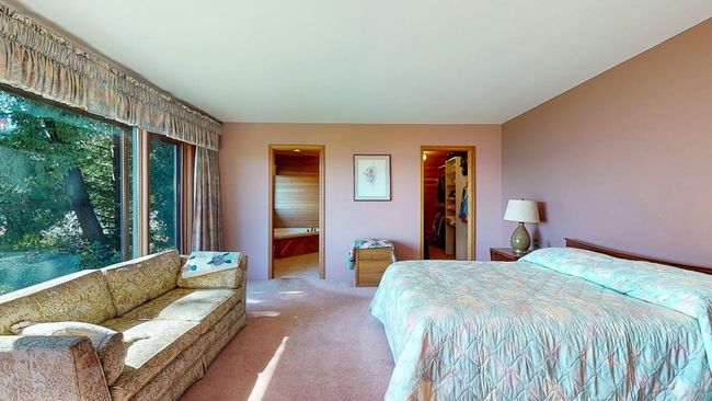 Carpeted bedroom with a walk in closet, multiple windows, and full ensuite | Image 27