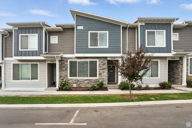 Townhome featuring board and batten siding and stone siding | Image 6