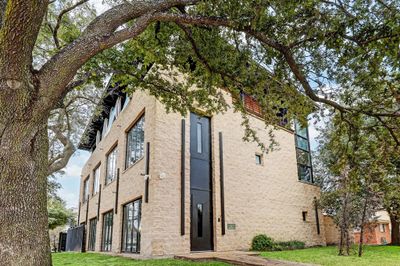 Located on the corner of Kirby and Amherst, this three-story contemporary home offers close proximity to Rice Village while also offering privacy and modern living. | Image 1