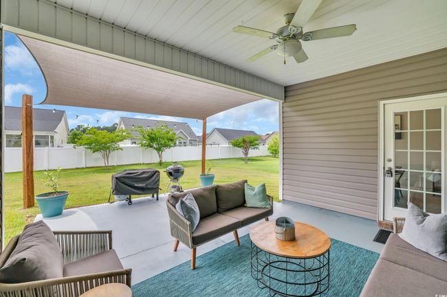 View of patio / terrace featuring a fenced backyard, an outdoor living space, ceiling fan, and area for grilling | Image 35